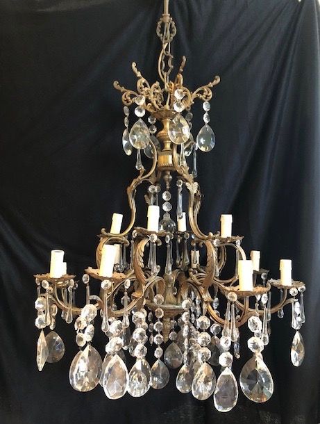 a large twelve light dark framed italian two tier antique chandelier