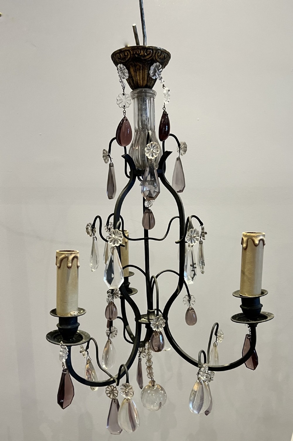 a pair of french three light dark framed antique chandeliers with amethyst crystals