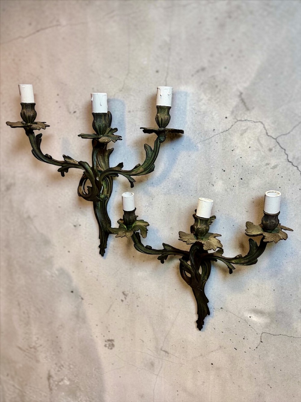 a set of 4 french triple arm antique brass wall lights